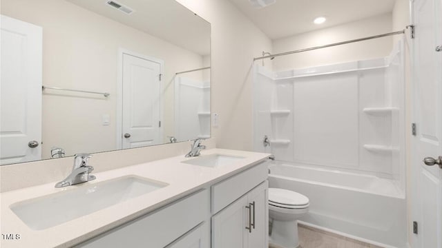 bathroom with double vanity, bathing tub / shower combination, a sink, and visible vents