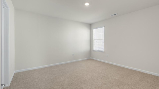 unfurnished room featuring light carpet, recessed lighting, visible vents, and baseboards