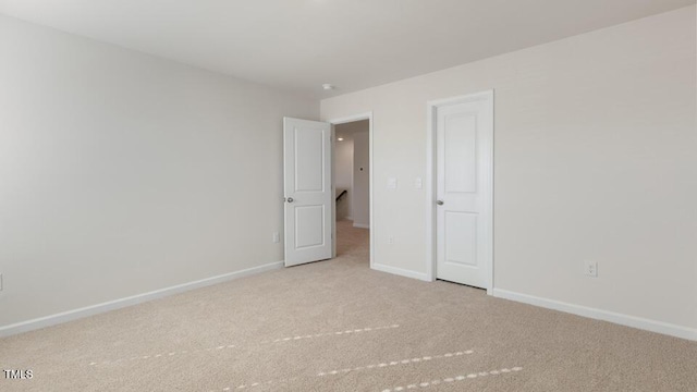 empty room with light carpet and baseboards