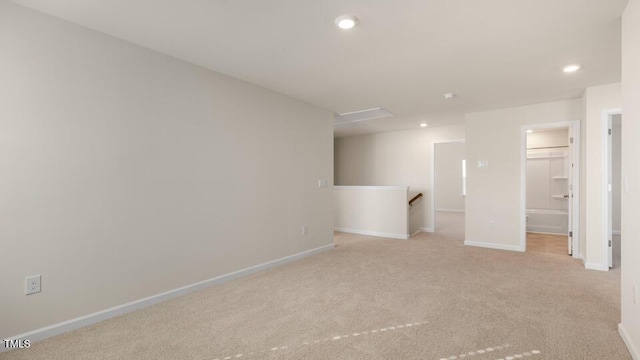 spare room featuring baseboards, recessed lighting, and light colored carpet