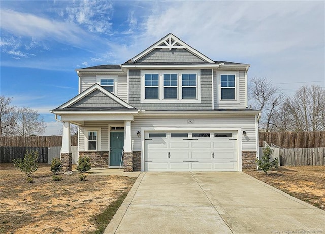 craftsman inspired home featuring a garage, stone siding, concrete driveway, and fence