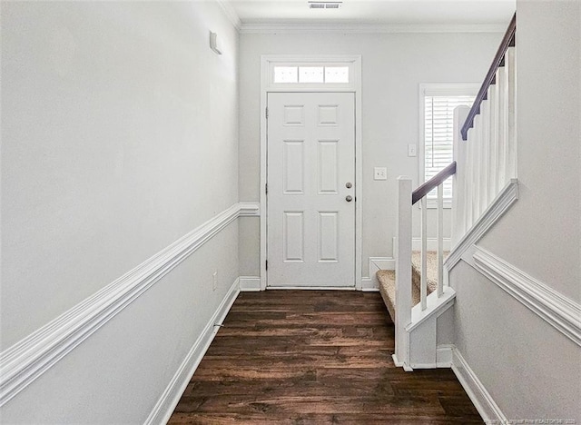 entryway with crown molding, visible vents, stairway, and dark wood-type flooring