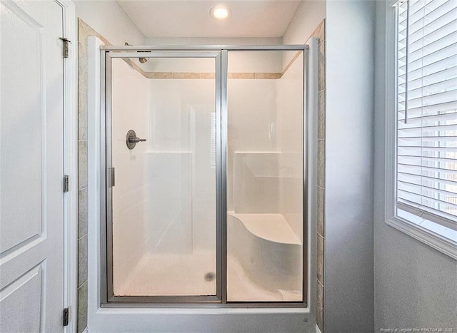 full bath featuring a shower stall