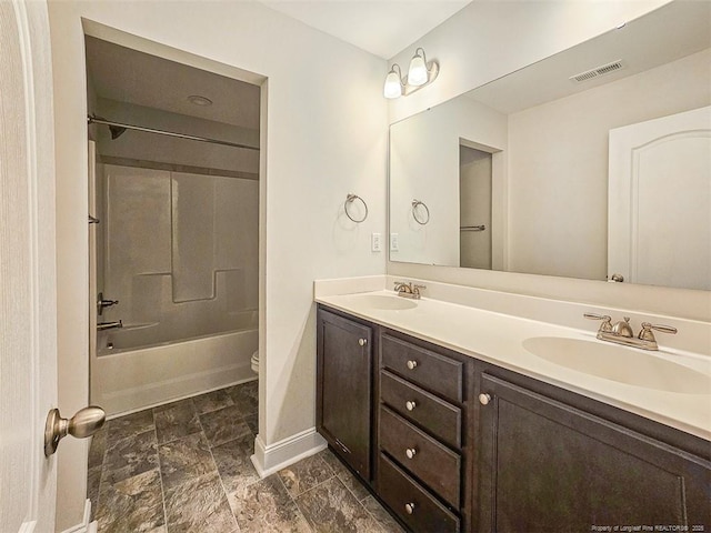 bathroom with visible vents, a sink, toilet, and double vanity