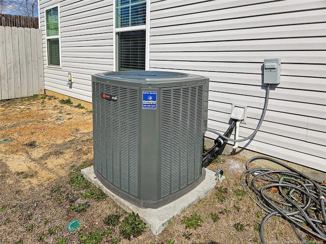 details featuring cooling unit and fence