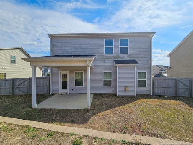 rear view of house featuring a patio area and a fenced backyard