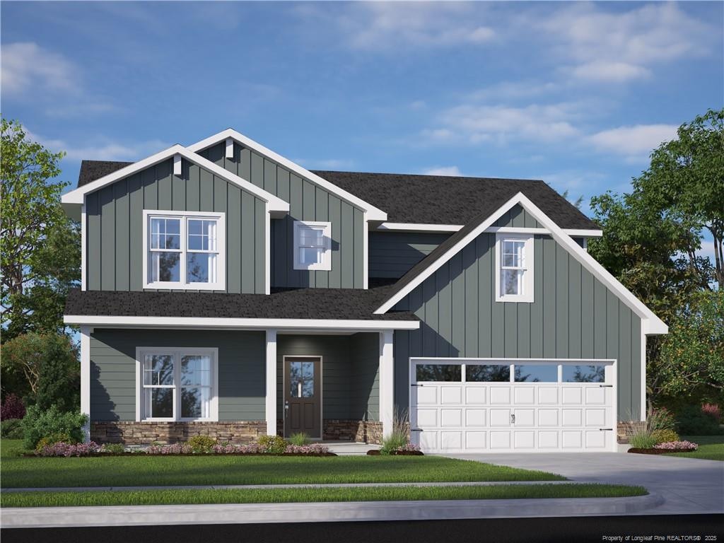 view of front of house with driveway, a garage, roof with shingles, board and batten siding, and a front yard