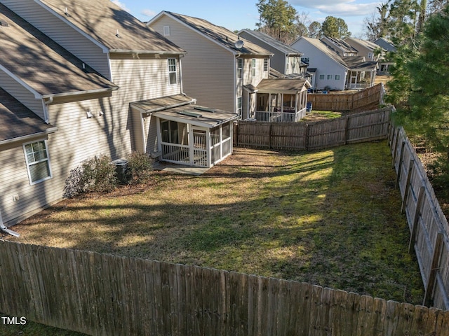 view of yard with a fenced backyard and a residential view