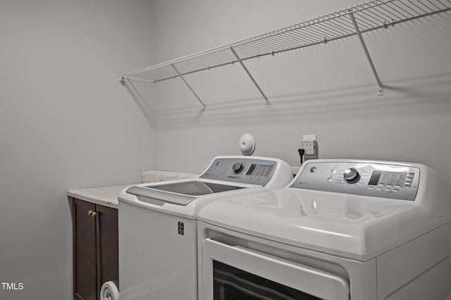 laundry area featuring cabinet space and separate washer and dryer