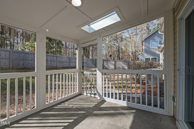 unfurnished sunroom featuring a skylight