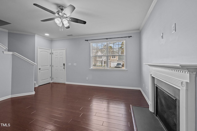 unfurnished living room with baseboards, ornamental molding, and wood finished floors