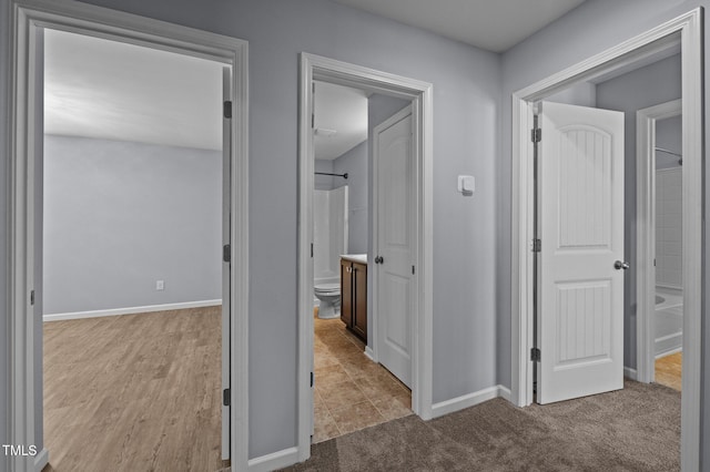 hall with carpet and baseboards