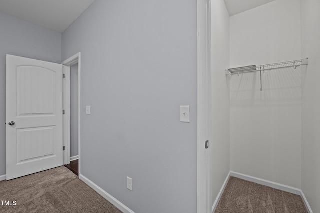 interior space featuring carpet and baseboards