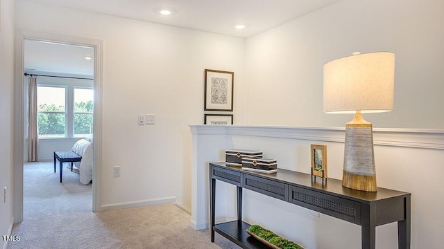 corridor featuring light carpet, recessed lighting, and baseboards