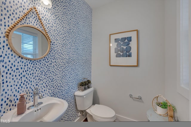 bathroom with toilet and a sink