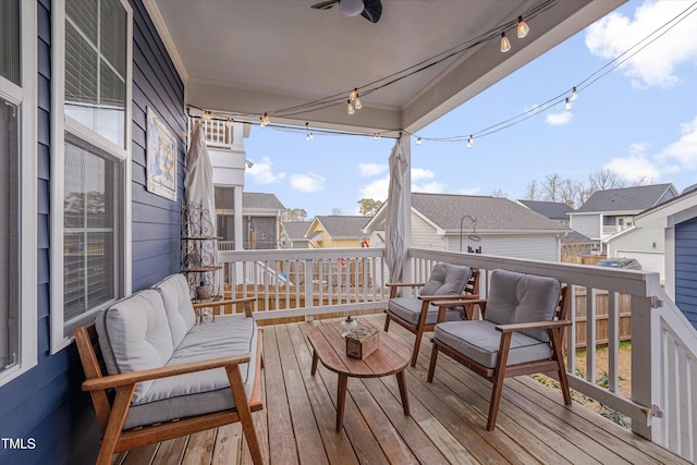 wooden deck with a residential view and an outdoor hangout area