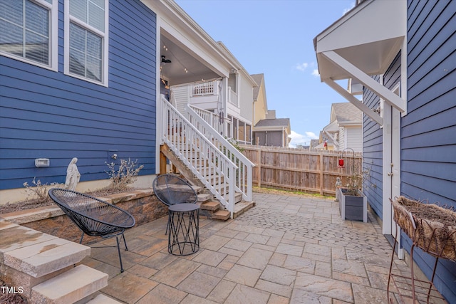 view of patio / terrace with stairs and fence