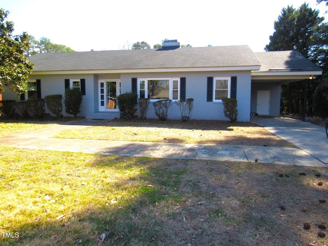 ranch-style home with an attached carport, a front yard, and brick siding