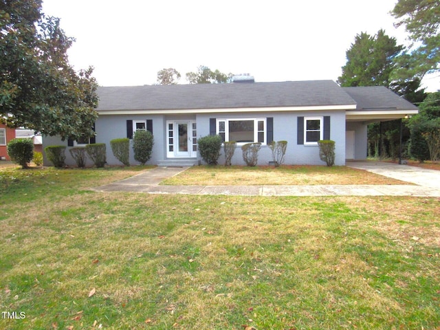 ranch-style home featuring an attached carport, brick siding, and a front lawn