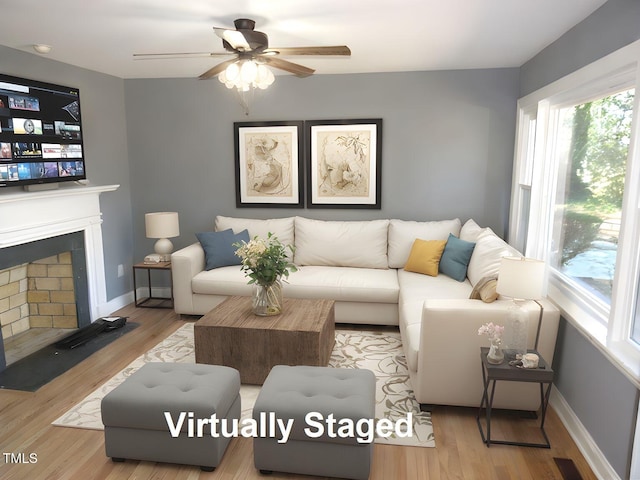 136 Dogwood Trl, Wendell, NC 27591 - living area with a fireplace with flush hearth, a ceiling fan, wood finished floors, and baseboards