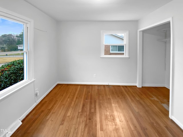 unfurnished bedroom featuring visible vents, baseboards, and wood finished floors