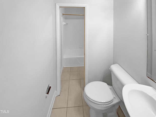full bathroom featuring tile patterned flooring, a sink, toilet, and shower / bathtub combination