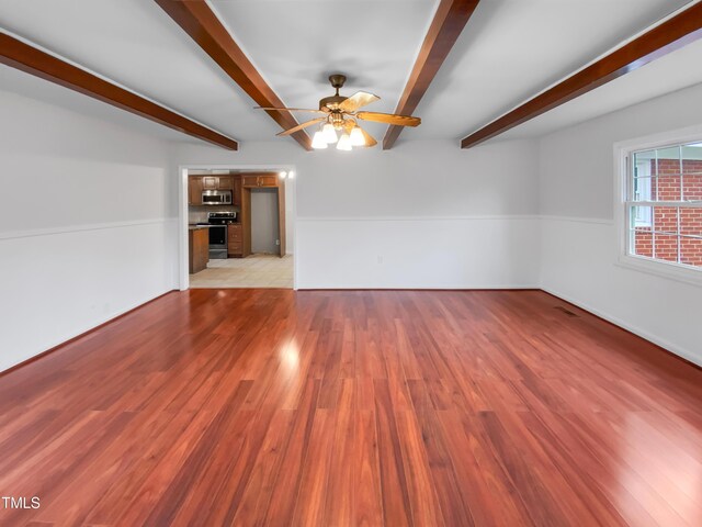 unfurnished living room with a ceiling fan, beam ceiling, and light wood finished floors
