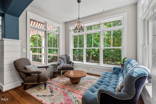 sunroom with plenty of natural light and a chandelier