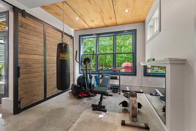 workout room with wooden ceiling and recessed lighting