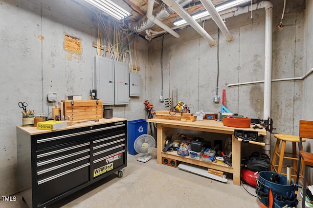 unfinished below grade area with a workshop area and electric panel