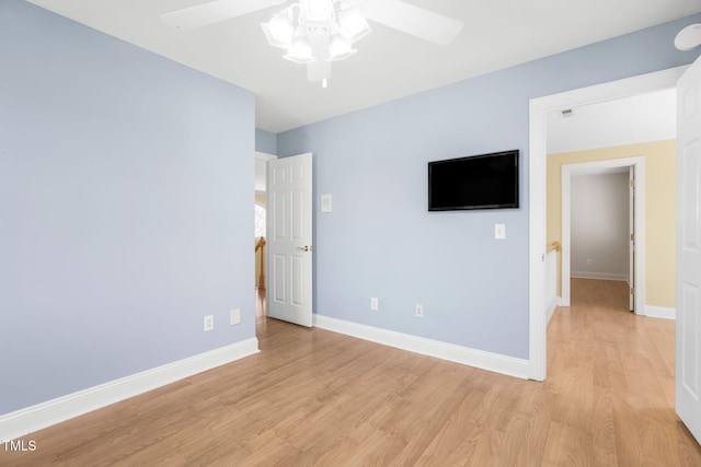 unfurnished bedroom with light wood-type flooring, ceiling fan, and baseboards