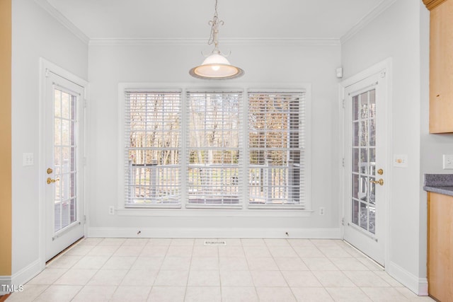 unfurnished dining area featuring ornamental molding, baseboards, and light tile patterned floors