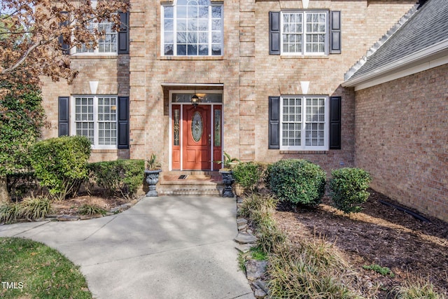 doorway to property with brick siding