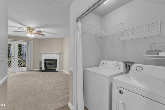 410 Oak Run Dr, Raleigh, NC 27606 - washroom with washer and clothes dryer, ceiling fan, a textured ceiling, a fireplace with flush hearth, and carpet flooring