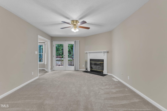 410 Oak Run Dr, Raleigh, NC 27606 - unfurnished living room with a ceiling fan, carpet, a fireplace with flush hearth, and a textured ceiling