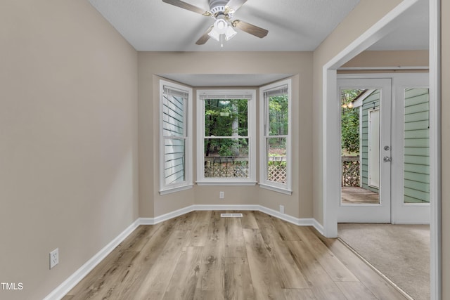 410 Oak Run Dr, Raleigh, NC 27606 - unfurnished room featuring plenty of natural light, light wood-style floors, and ceiling fan