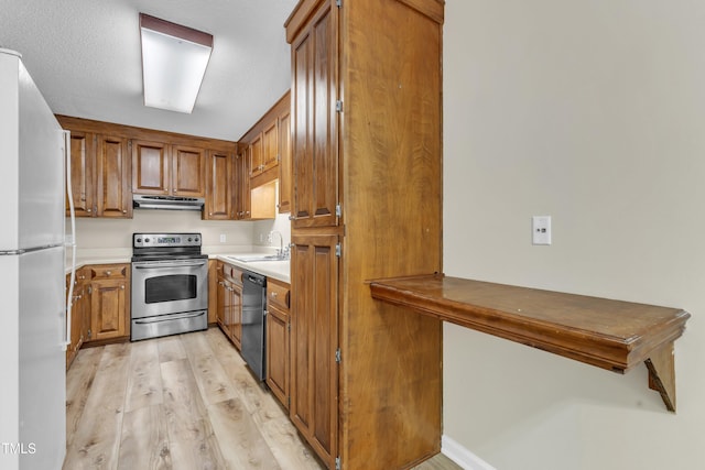 410 Oak Run Dr, Raleigh, NC 27606 - kitchen featuring stainless steel range with electric cooktop, freestanding refrigerator, dishwasher, under cabinet range hood, and brown cabinetry
