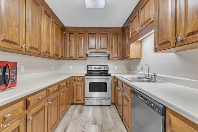 410 Oak Run Dr, Raleigh, NC 27606 - kitchen featuring appliances with stainless steel finishes, exhaust hood, brown cabinetry, light wood finished floors, and light countertops