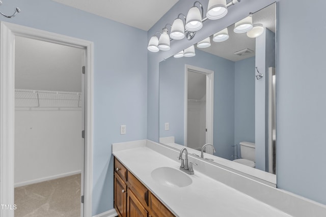 410 Oak Run Dr, Raleigh, NC 27606 - bathroom featuring vanity and a spacious closet