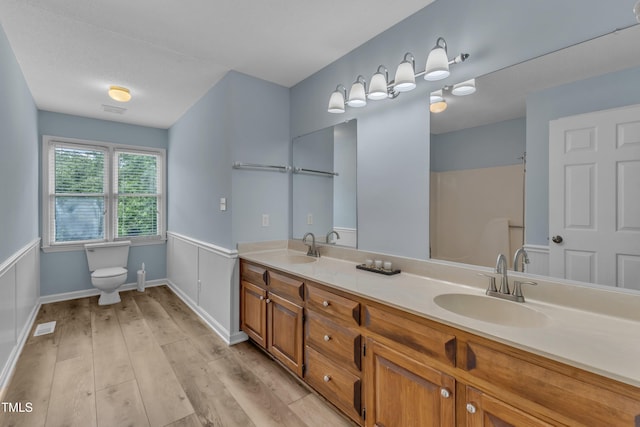 410 Oak Run Dr, Raleigh, NC 27606 - full bathroom featuring wood finished floors and double vanity