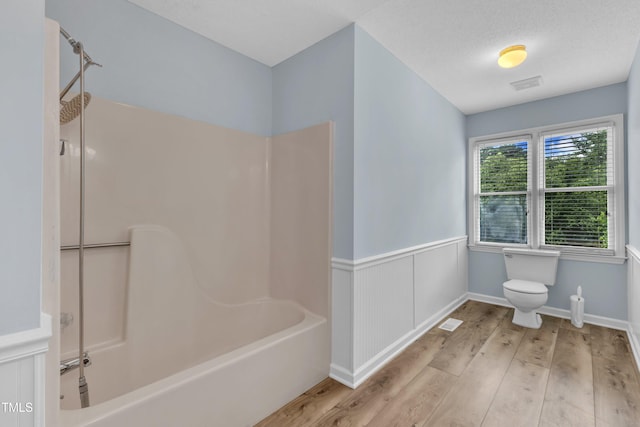 410 Oak Run Dr, Raleigh, NC 27606 - bathroom featuring wood finished floors,  shower combination, and a wainscoted wall