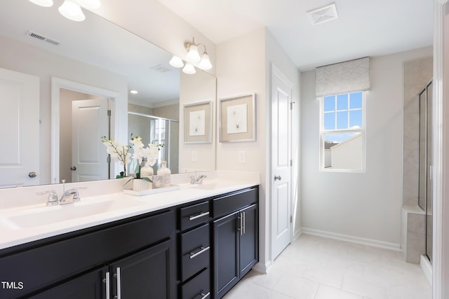 bathroom featuring a stall shower, visible vents, and a sink