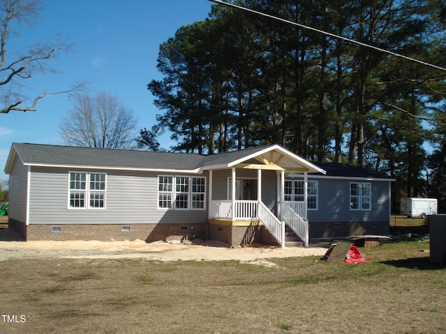 view of front of home with crawl space, covered porch, and a front lawn