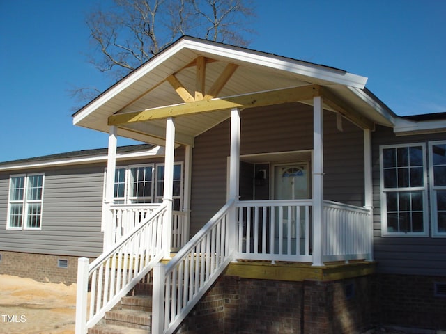 entrance to property with covered porch and crawl space