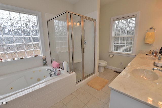 bathroom with double vanity, tile patterned flooring, a sink, and a shower stall