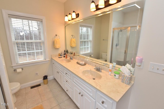 full bathroom featuring toilet, a stall shower, visible vents, and a sink