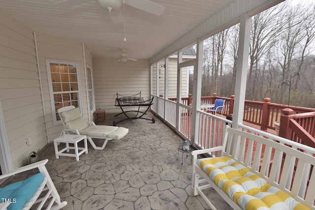 sunroom / solarium featuring ceiling fan
