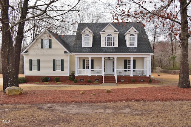 cape cod-style house featuring a porch, crawl space, and roof with shingles