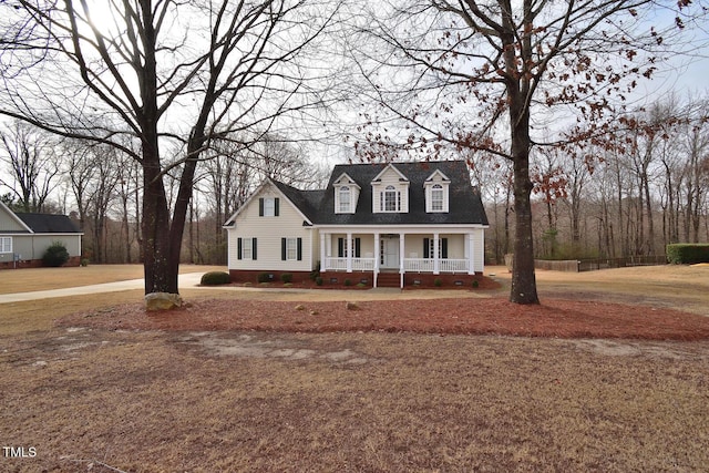 cape cod-style house featuring covered porch