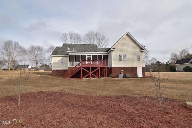 rear view of property with a sunroom, stairs, cooling unit, and a yard